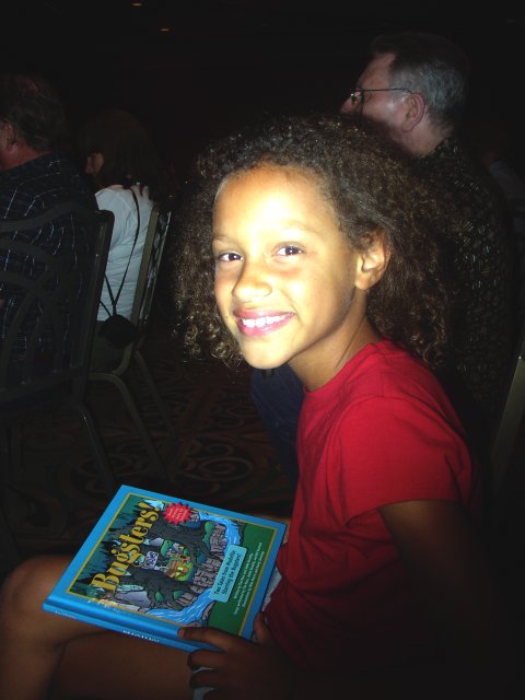 Tim's daughter Madison, reading "Bugsters" during her father's concert